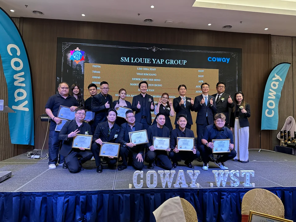 Group holding certificates on a Coway stage