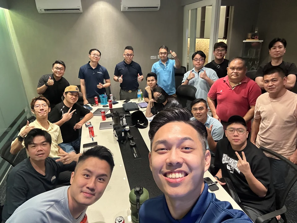 Team members posing around a meeting table
